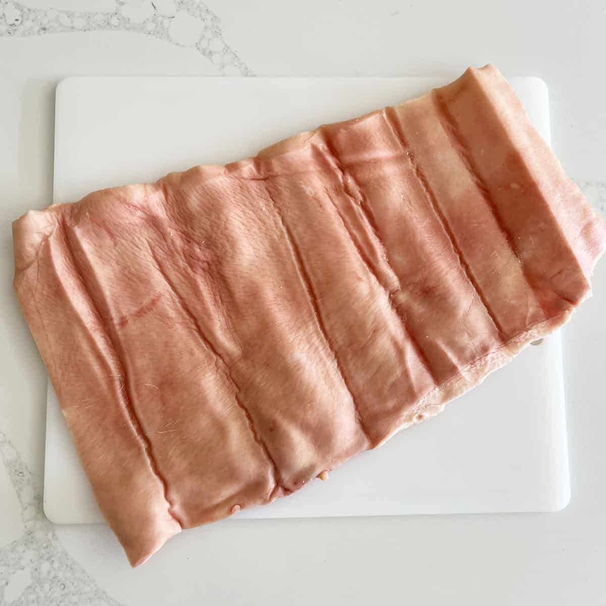 Pork skin on a cutting board.