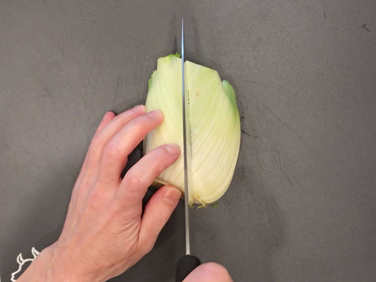 Prepping the fennel: slicing the bulb in half.