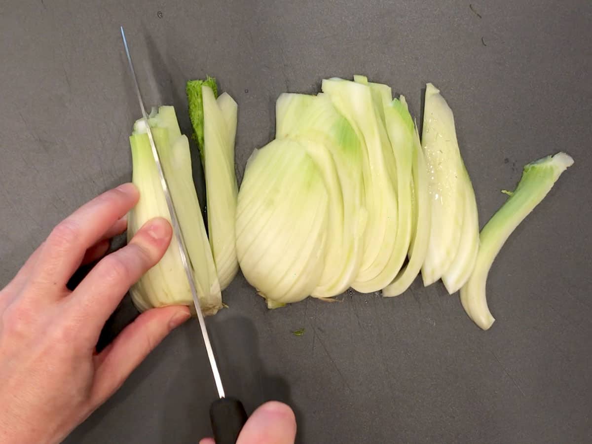 Prepping the fennel: cutting the bulb into slices.