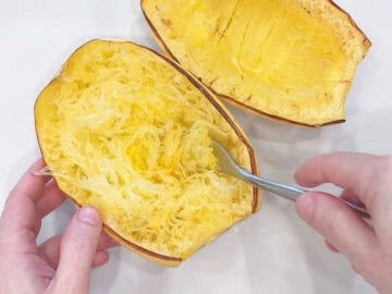 Using a fork to create the squash strands.