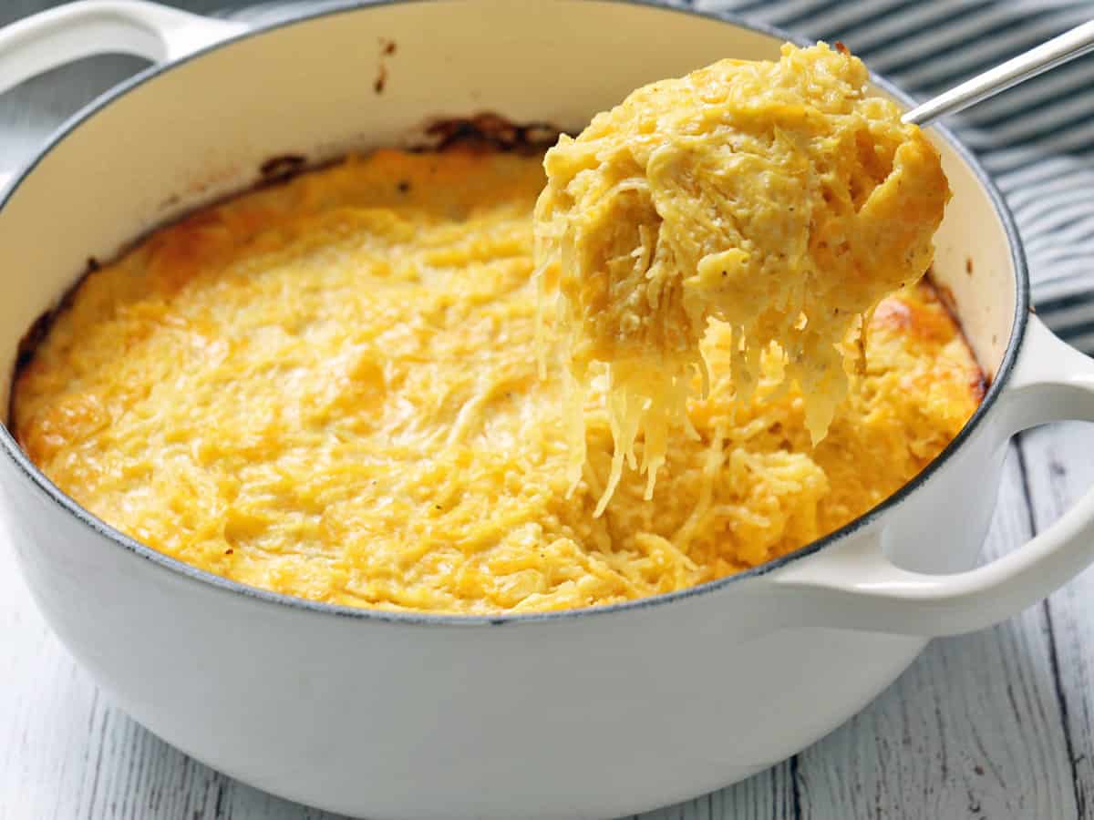Spaghetti squash casserole is scooped out of the baking dish.