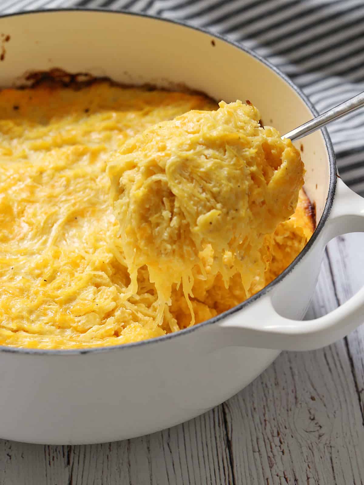 Spaghetti squash casserole is scooped out of the baking dish.