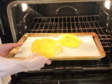 Placing the squash in the oven.