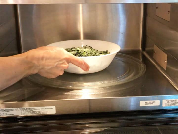 Thawing the spinach in the microwave.
