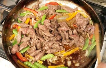 The sauce and beef strips were added to the skillet.