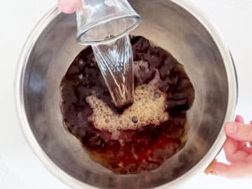 Adding water to the tea.