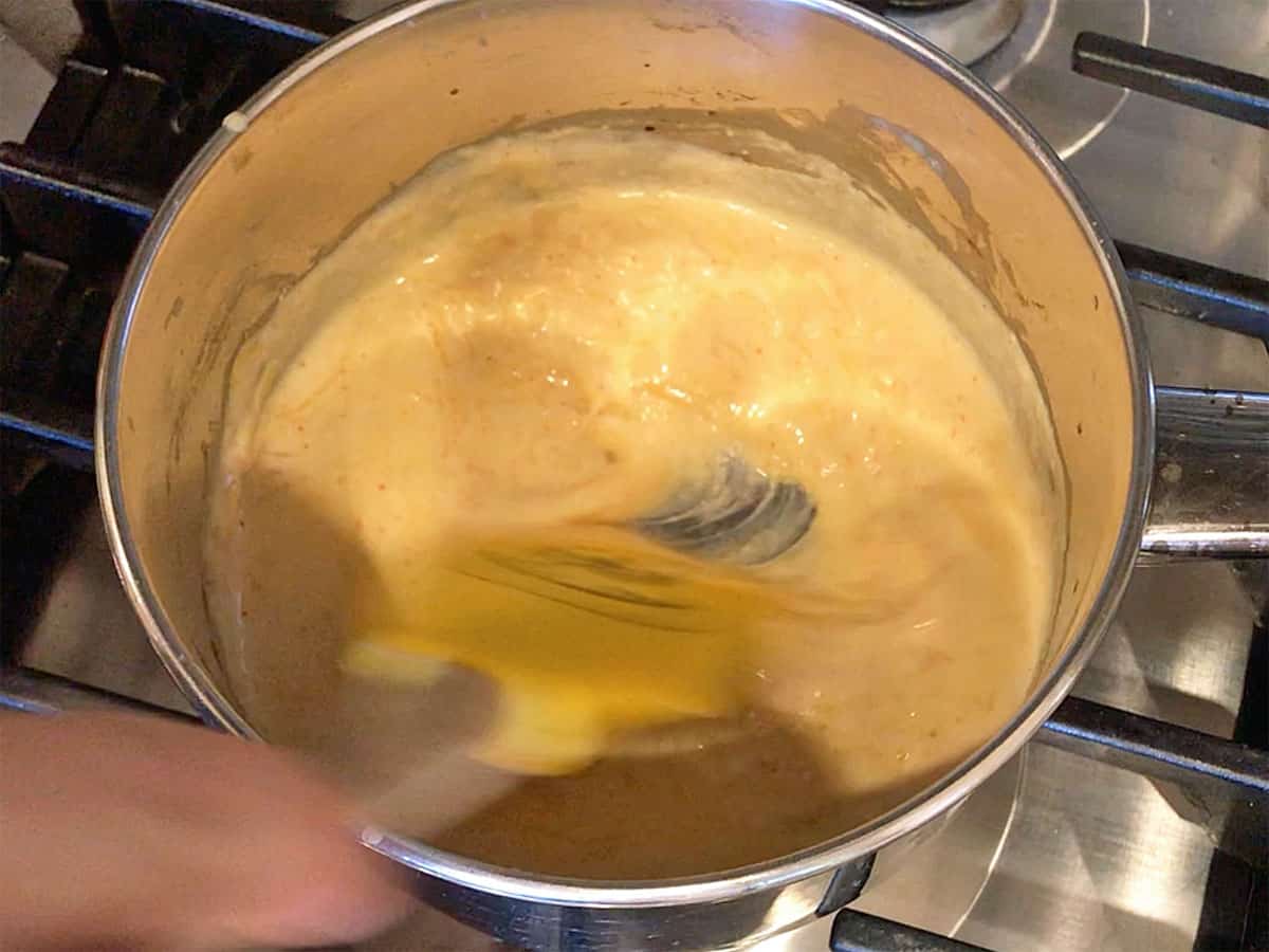 Mixing in the cheese.