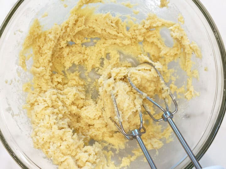 Adding almond flour to the batter.