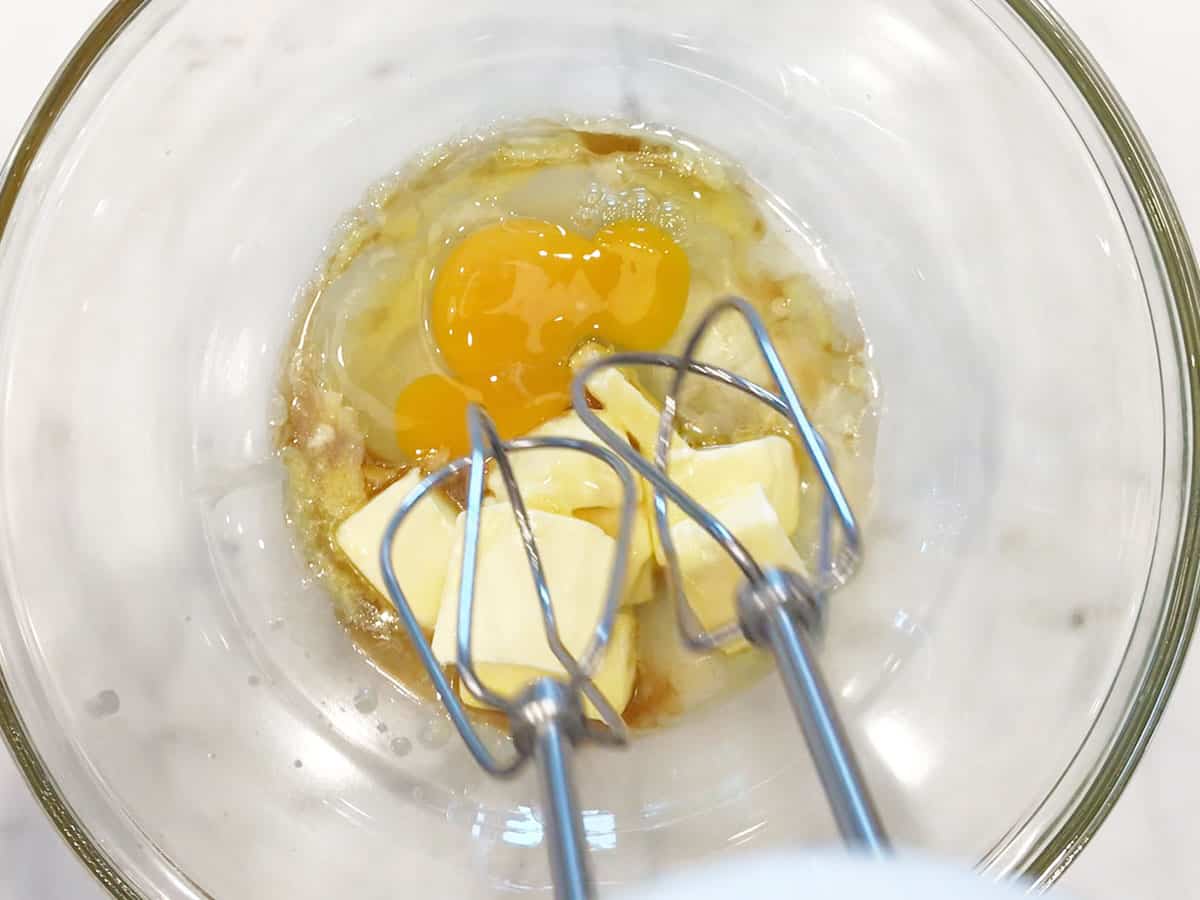Mixing butter, stevia, vanilla, and eggs.