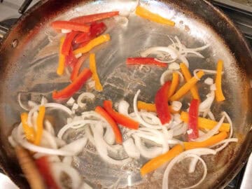 Cooking the onions and peppers.