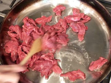 Cooking the beef strips.