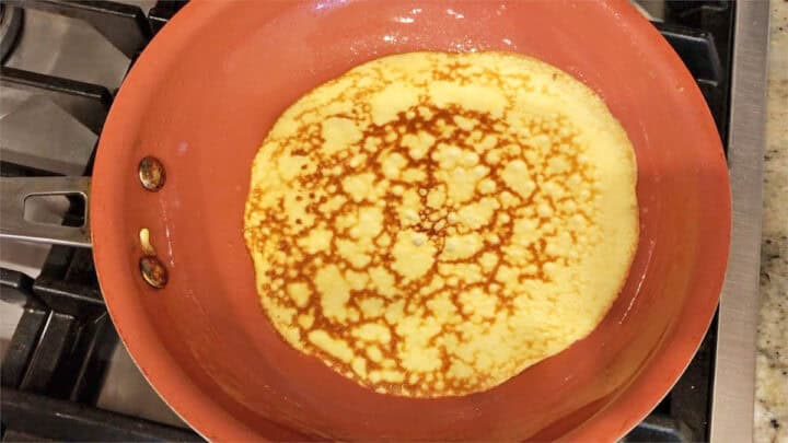 Cooking a keto crepe on the second side.