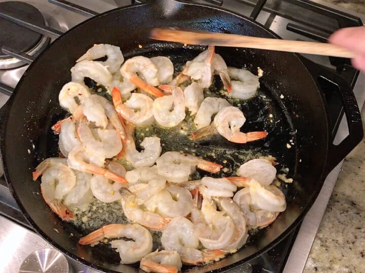 Cooking the shrimp in a skillet.