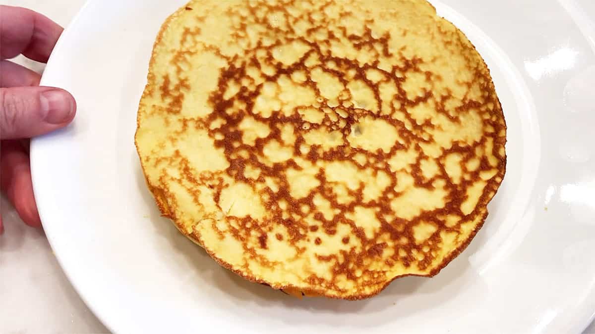 Keto crepes are piled on a plate.