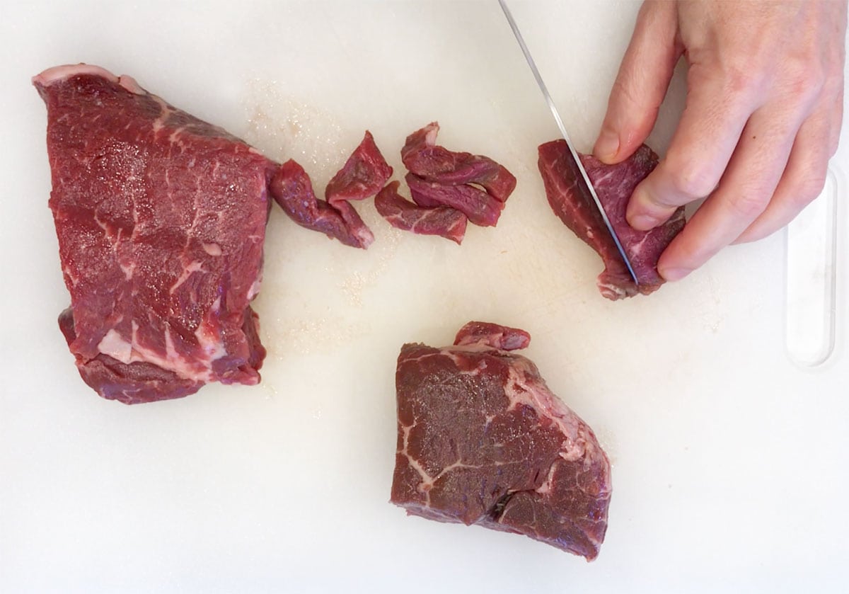 Cutting the beef into strips.