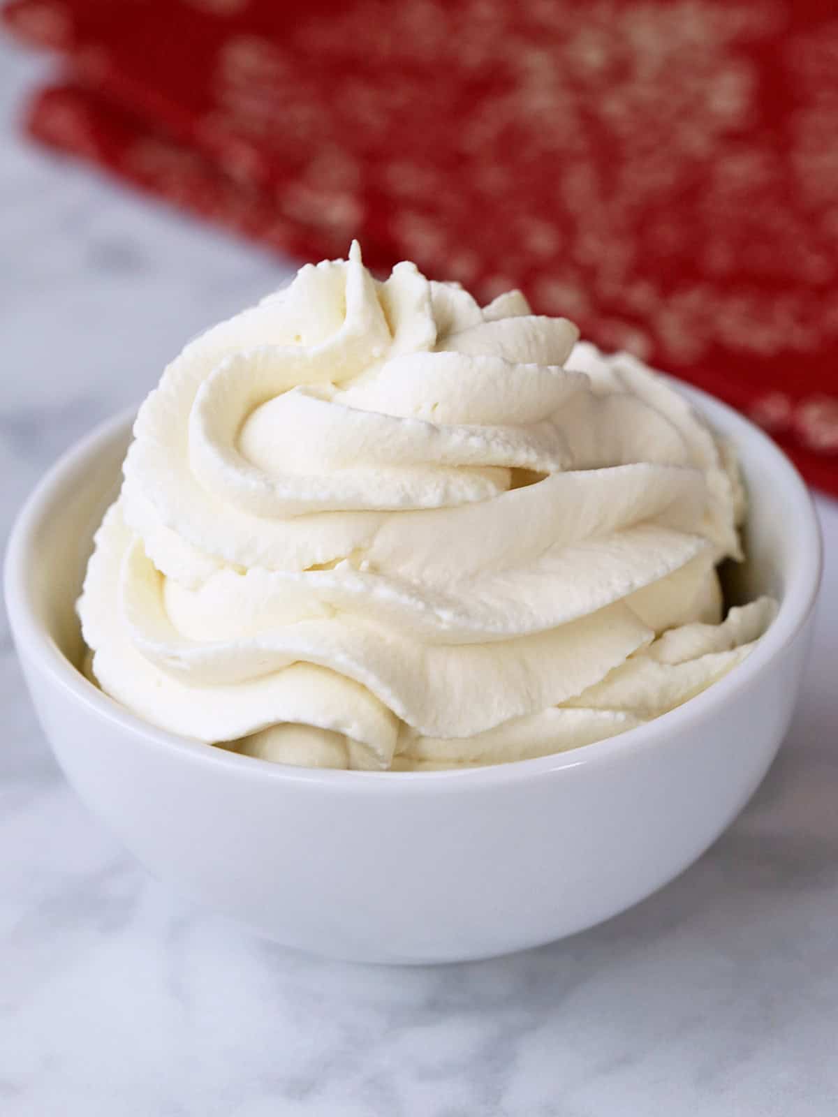 Keto whipped cream is served in a bowl with a napkin.