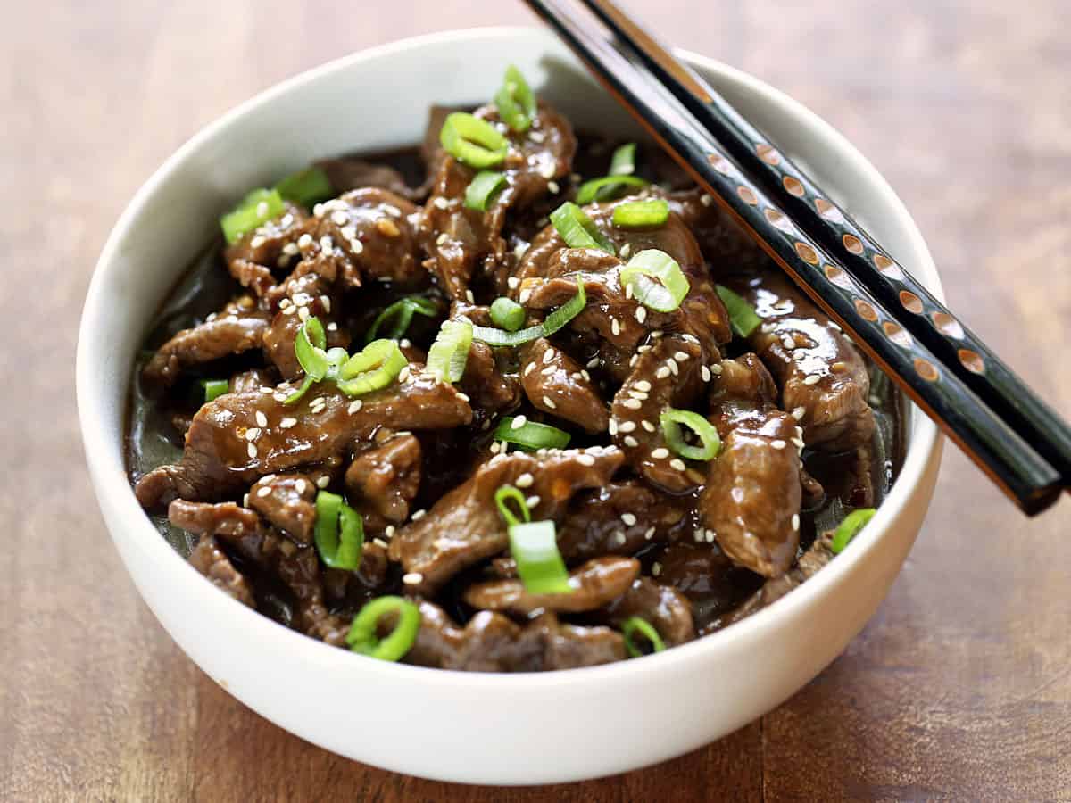 Korean beef is served in a bowl with chopsticks.