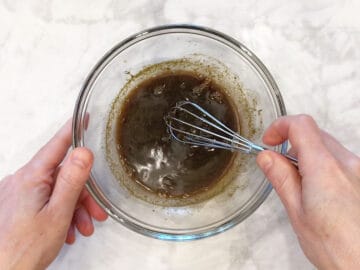Mixing the sauce in a bowl.