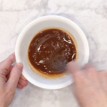Mixing the sauce in a bowl.