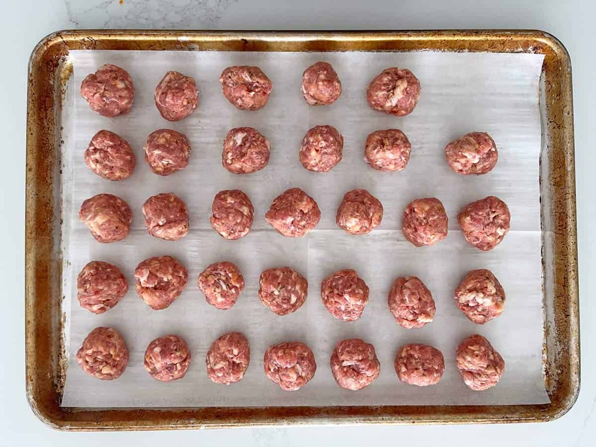 One-ingredient meatballs in the pan before being baked.