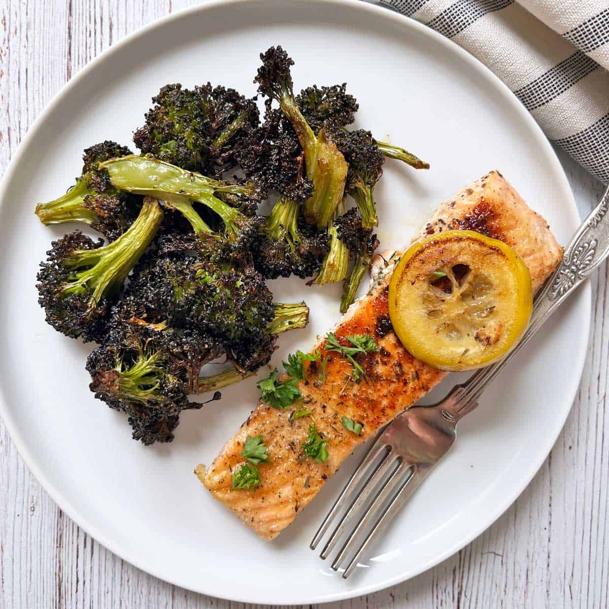 Pan-seared salmon is served with roasted broccoli.
