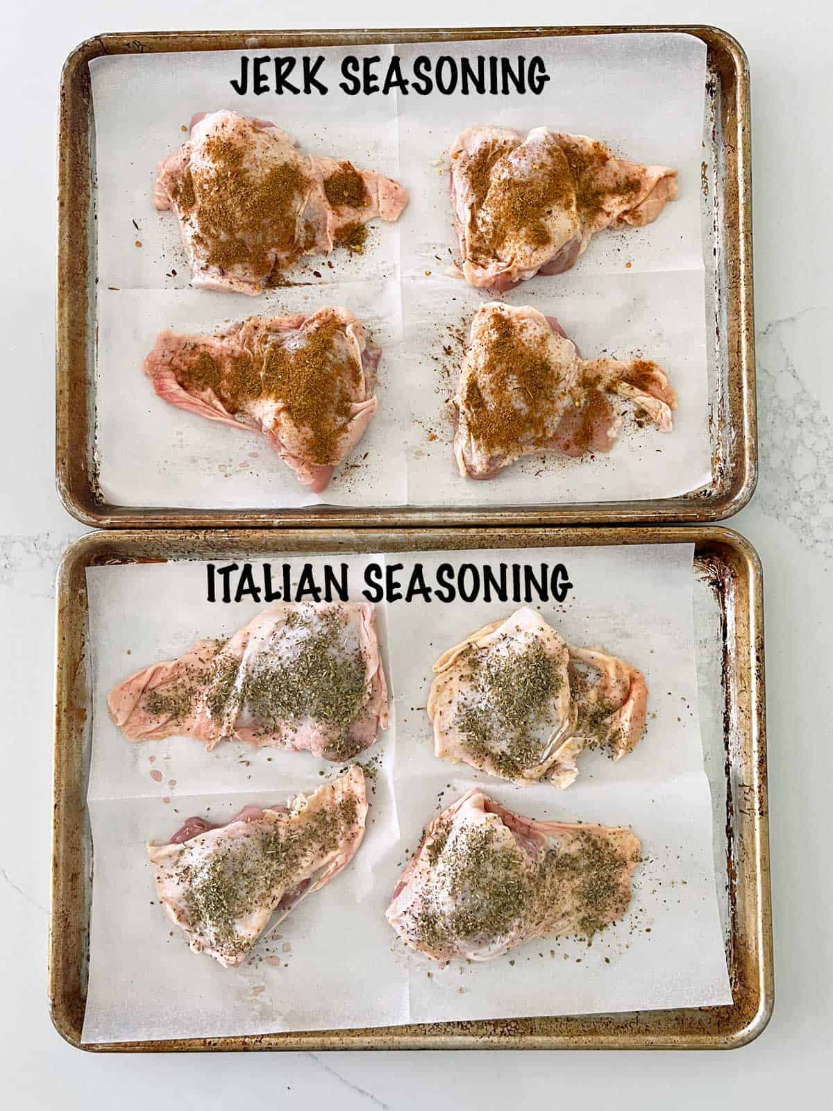 Two pans with seasoned chicken thighs: one with jerk seasoning and one with Italian seasoning.