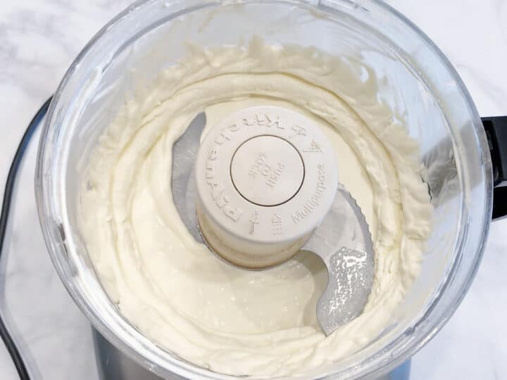 The whipped cream is ready in the food processor.