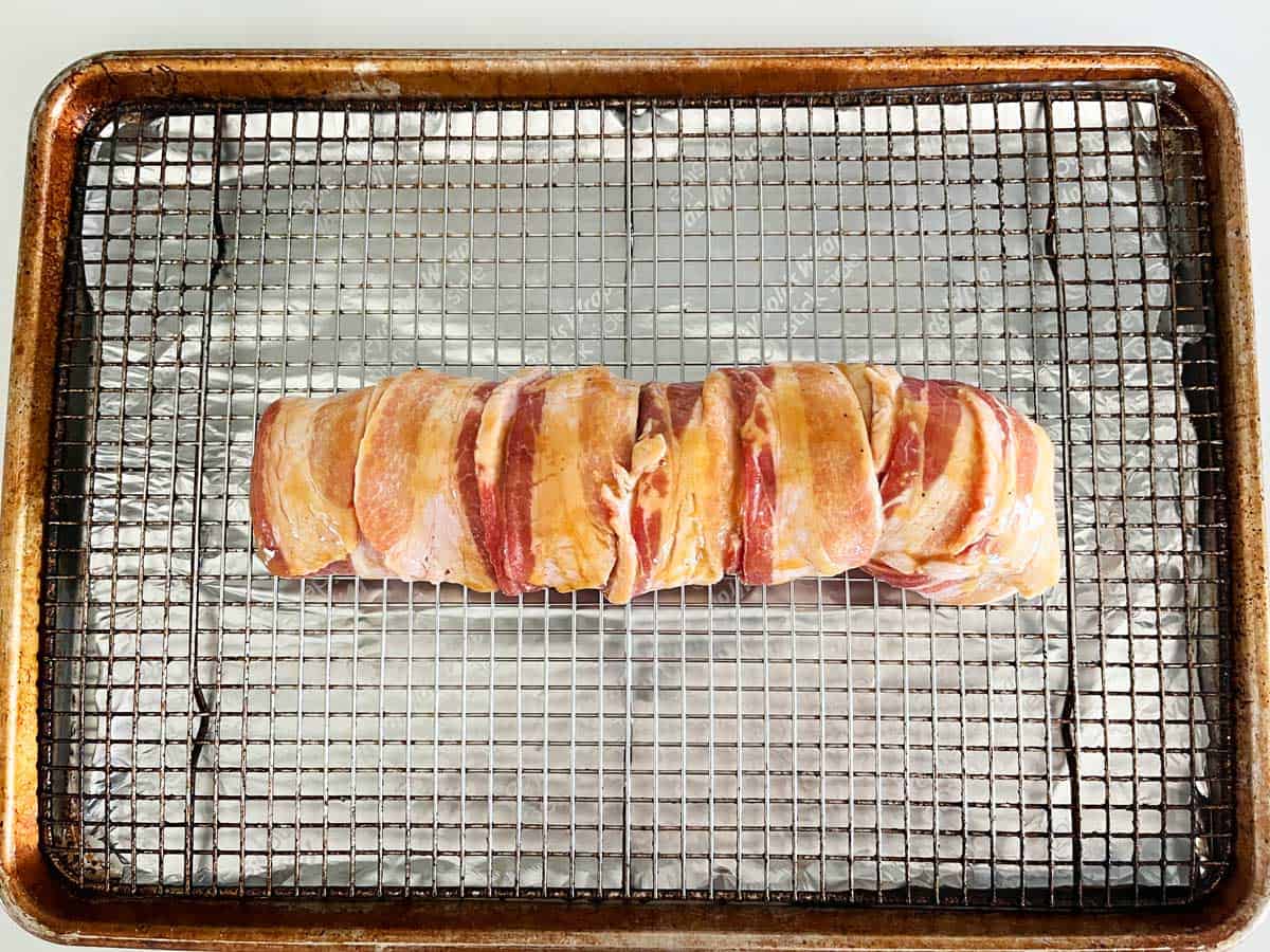 The wrapped and glazed tenderloin was placed on the prepared baking sheet.