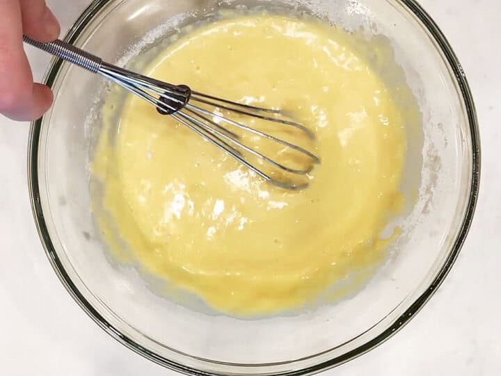 Whisking the batter one more time.