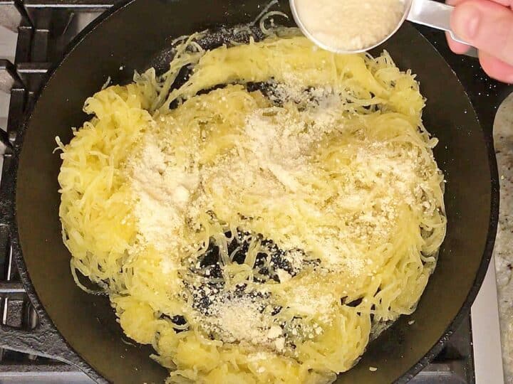 Adding grated parmesan.