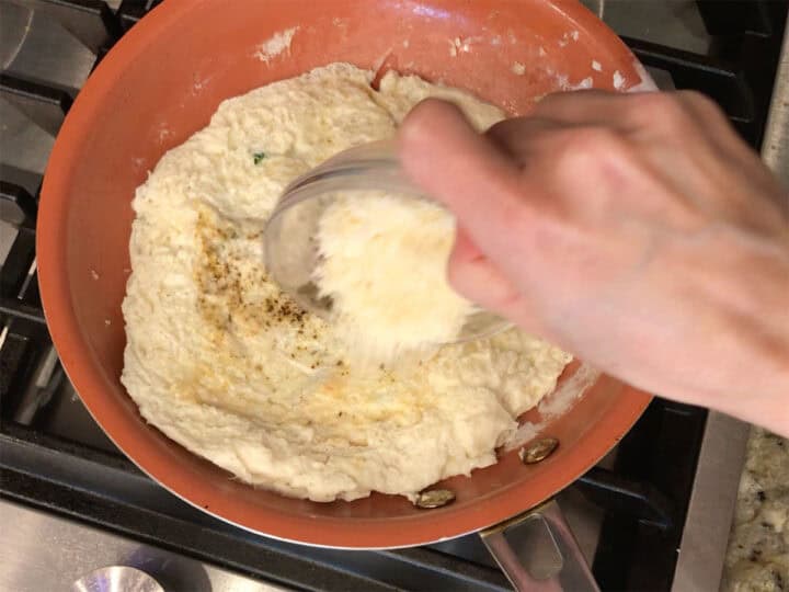 Adding parmesan.