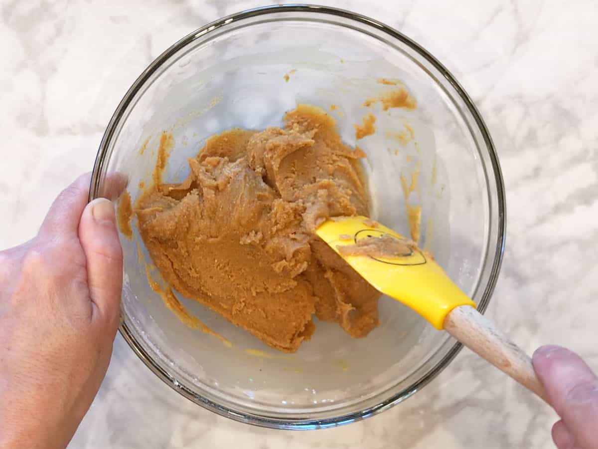 Adding peanut butter to the mixture.