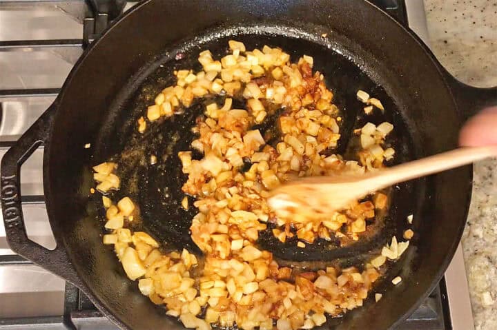 Adding spices to the onions.