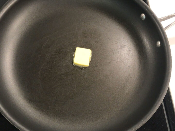 Adding more butter to the skillet.