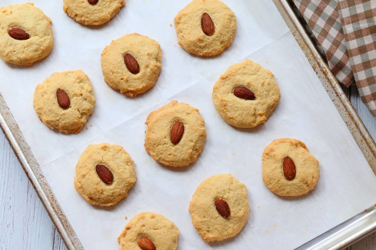 Almond flour cookies on a parchment-lined baking sheet.