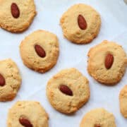Almond flour cookies on a parchment-lined baking sheet.