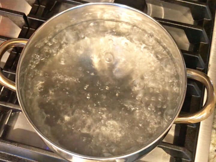 Bringing water to a boil in a saucepan.