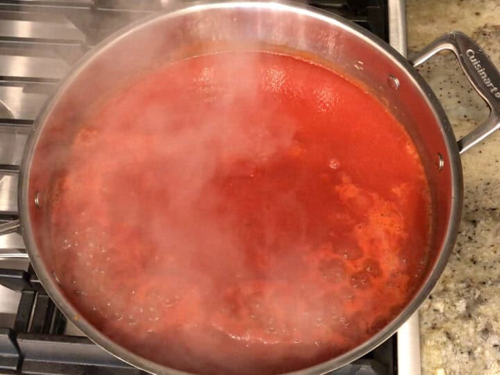 Bringing the soup to a boil.