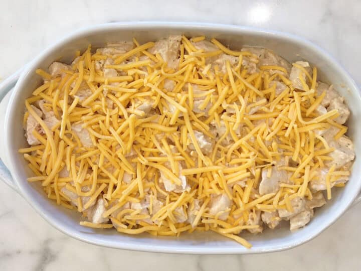 The casserole was topped with cheese and is ready to be baked.