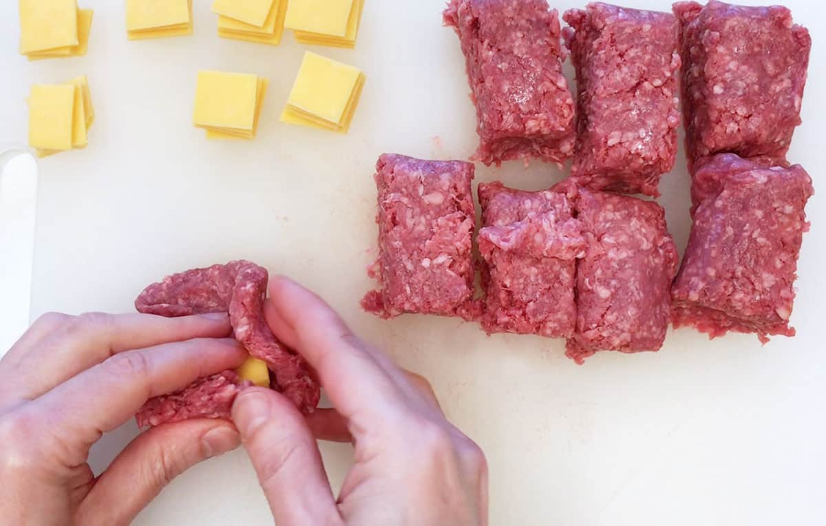 Placing cheese inside the meat.