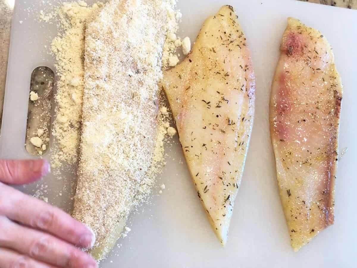 Coating the fish in almond flour.