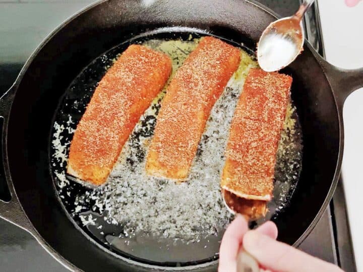 Cooking the salmon, skin side down.