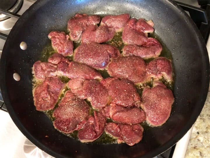 Cooking the livers in a skillet.