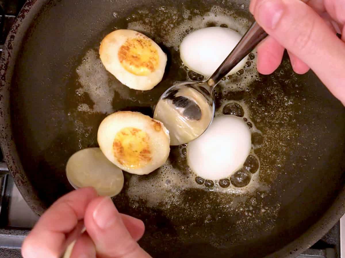 Frying the eggs in a skillet.