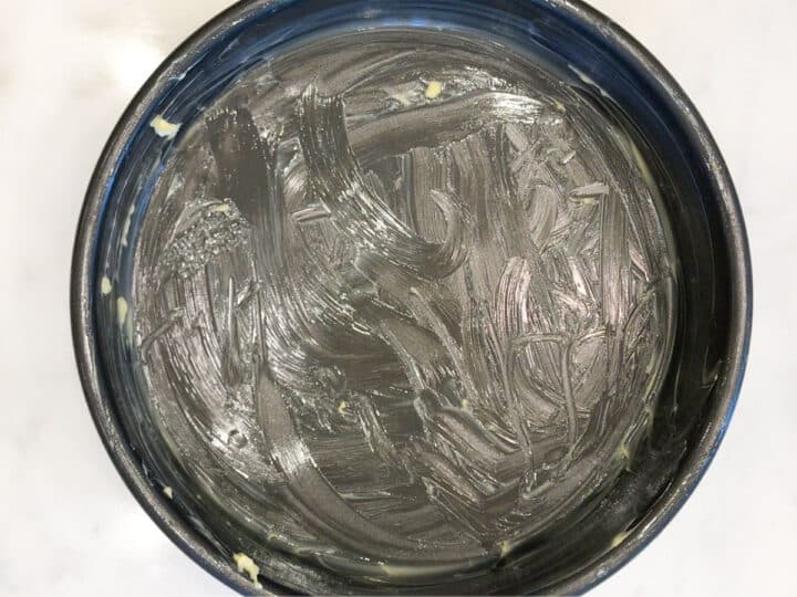 A cake pan greased with butter.