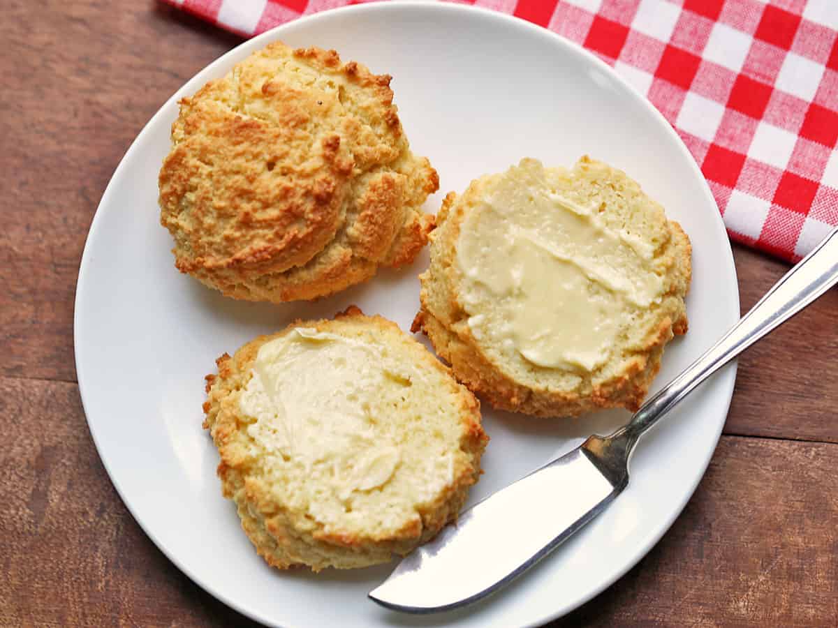 Keto biscuits are topped with butter.