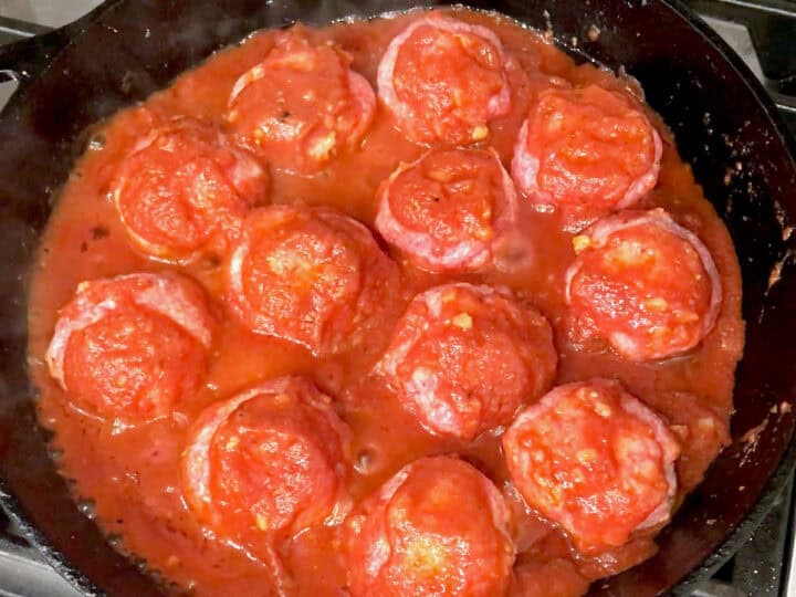 The meatballs were added to the sauce in the skillet.