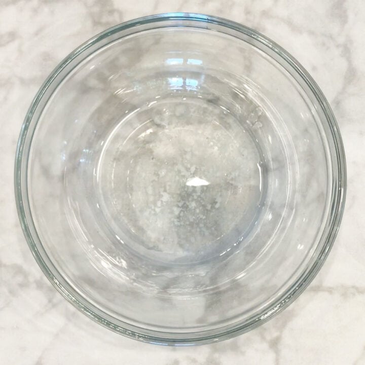 Melted coconut oil in a small bowl.