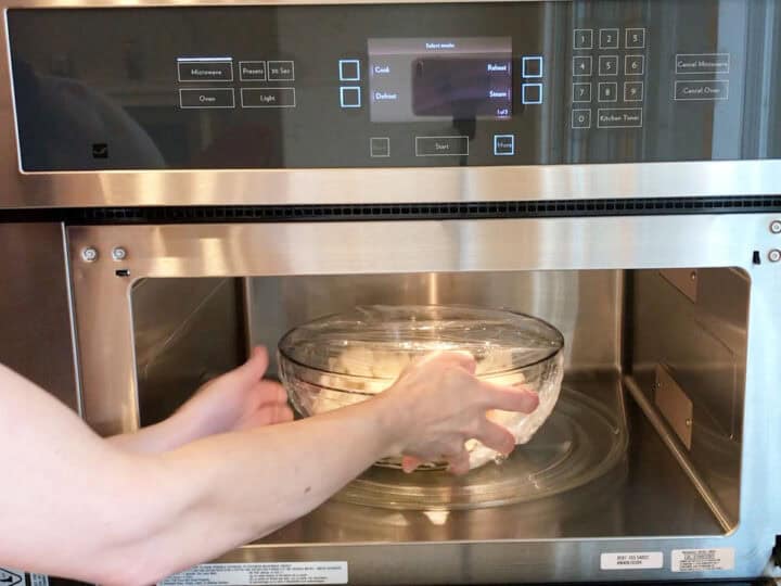 Placing the cauliflower in the microwave.