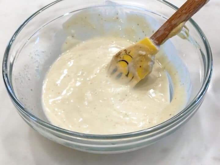 Mixing the dressing ingredients in a bowl.
